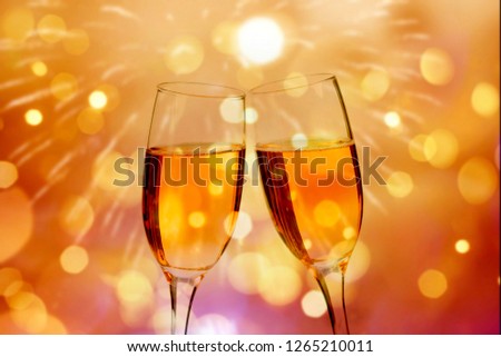 Champagne glasses on sparkling holiday background and fireworks - New Year concept