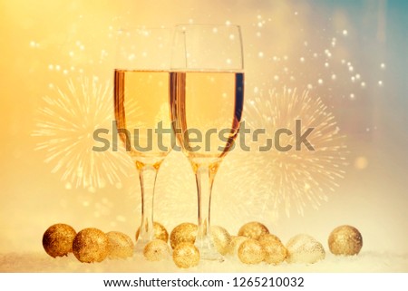 Champagne glasses on sparkling holiday background and fireworks - New Year concept