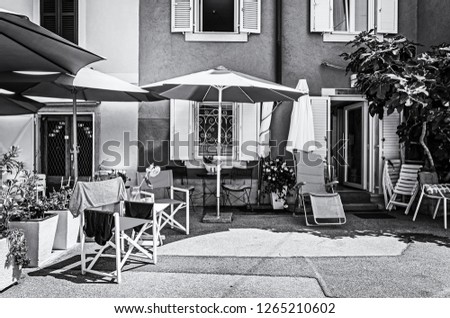 Colorful guest houses in Piran, Slovenia. Architectural theme. Accommodation and services. Black and white photo.