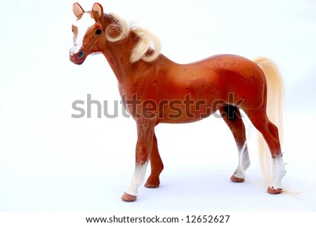 An old brown horse toy for children isolated on white background