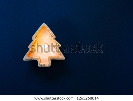 flat lay of burning candle in the shape of a Christmas tree