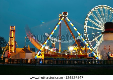 long exposure pictures of amusement park rides and wheels at night