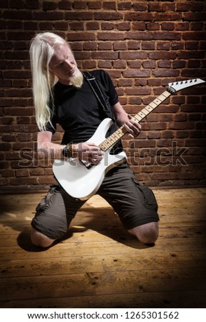 Playing white guitar in pub