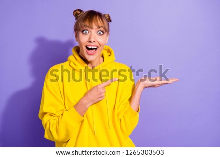 Close up photo of brunette she her lady front teeth trendy pretty hairstyle showing finger open palm announcing buy buyer low prices wearing casual bright yellow pullover isolated purple background
