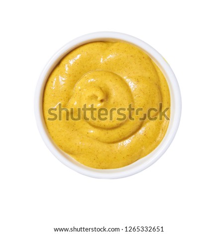 Mustard sauce in ceramic bowl isolated on white background. Portion of mustard sauce. Royalty-Free Stock Photo #1265332651