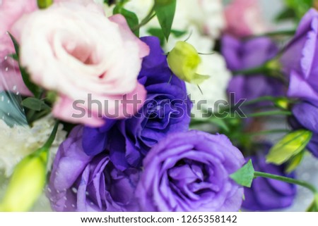 Romantic Bouquet of multicolored white, pink and purple roses and flowers among green twigs for lovers