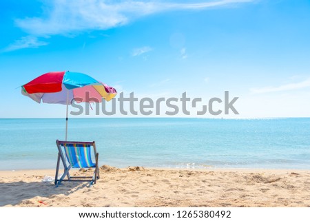 Beach chairs on the white sand beach with cloudy blue sky.tropical beach and blue sky