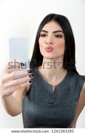 Business woman taking cell phone picture