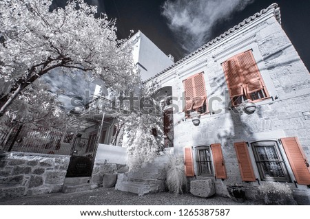 old greek house in the village surrounded snowy foliage infrared shot