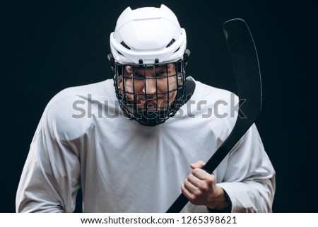 Handsome hockey player looking at camera asking the supporters if there is so any interest in going to that hockey game