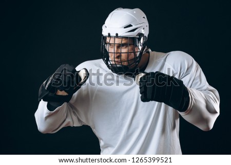 Emotional outraged ice-hockey player man gestures angrily, being provoked with the enemy, standing in fight pose. Sport, Negative emotions and rivalry concept Royalty-Free Stock Photo #1265399521
