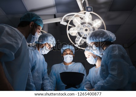 Attentive medical workers operating their patient