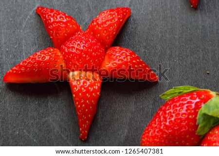 White plate with strawberries,star form and mixed on wood Chopping board,white plate. strawberry star design. Colorful of nature fresh fruits. Health food good life. red star ,fruit star, 