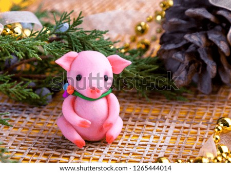 plastic pink pig cypress branch and bump. A Pig - symbol 2019 year, symbol of money and wealth. Pig card. Copy space