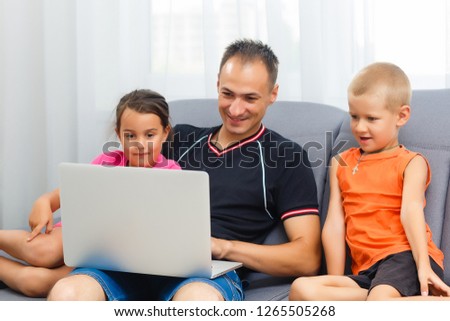 Father and children cartoon online at laptop, dad spending time together with kid playing game with daddy enjoying morning at home