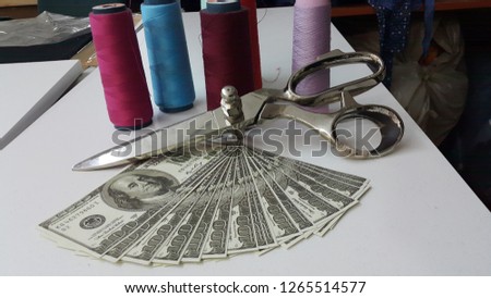 american dollar and tailor scissors
