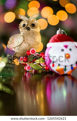 Christmas owl ornament with a backdrop of christmas tree