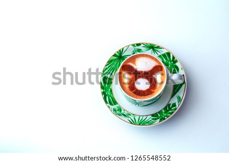 A cup of cappuccino coffee with a zodiac sign Taurus on milk foam