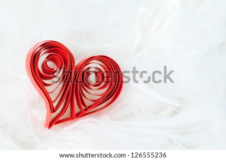 Red ribbon heart on white fluffy background