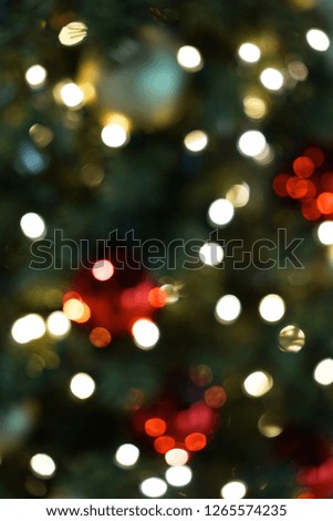 Blurred Decorated Christmas tree vith defocus shining lights background.