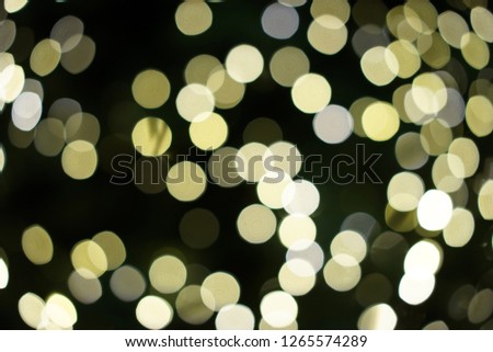 Blurred Christmas tree background lights with shining round bokeh.