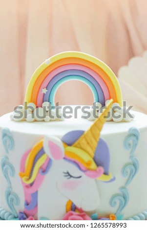 Detail of a birthday unicorn cake - focus on rainbow topper 