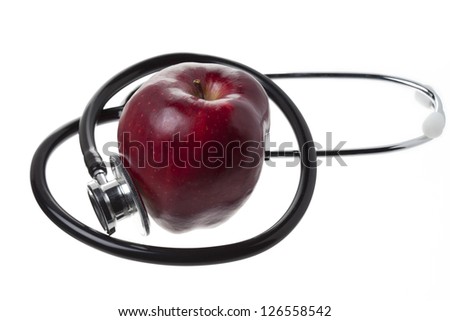 Health care checkup with apple and stethoscope isolated on white background