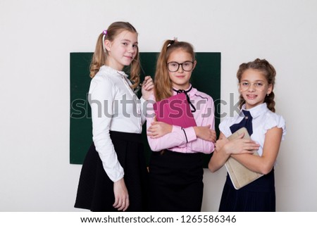 three girls in glasses at the Blackboard in a class lesson