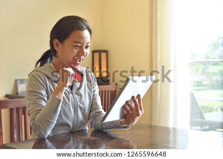 Happy woman doing online shopping at home