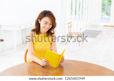 young attractive asian woman who reads a book