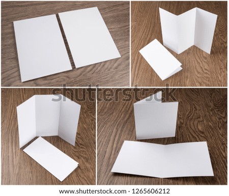 Set of white booklets on wooden background