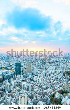 Asia Business concept for real estate and corporate construction - urban city skyline aerial night view under blue sky and neon light in Tokyo, Japan