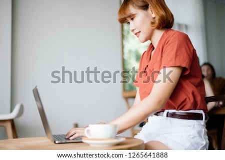 Asian business woman working in coffee shop cafe with laptop