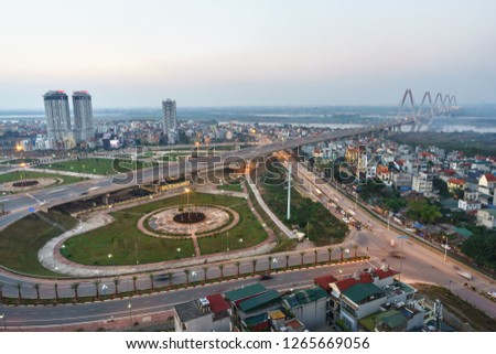 Aerial skyline view of Hanoi city, Vietnam. Hanoi cityscape by sunset period at roundabout to Nhat Tan bridge, Ho Tay district