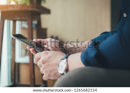 Young men wearing casual shirts.sit enjoy relax on sofa using cell phone.typing texting message chatting with friend.concept for modern communication in the business world financial Transactions 