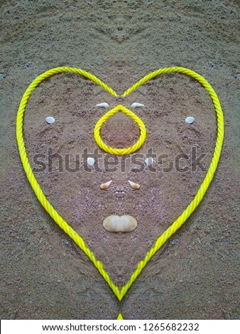 Heart made of rope on the sand - Image