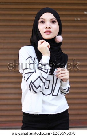 Cute Asian girl wearing hijab. Girl in white top. Modest fashion street style. Sweet heart face. 