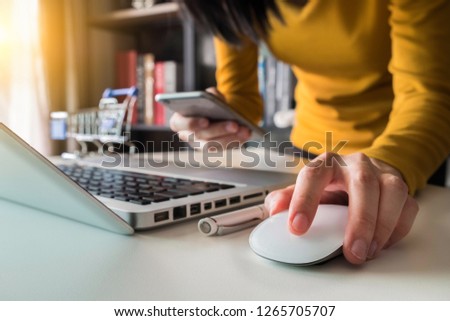 woman using smart phone for mobile payments online shopping,omni channel,sitting on table,virtual icons graphics interface screen. 