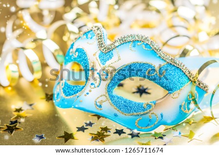 Carnival mask on festive party background with sparkles and confetti