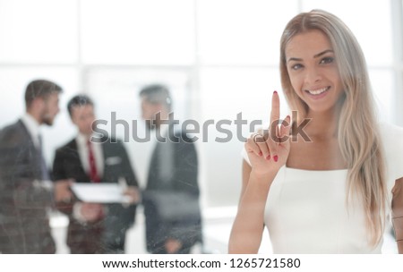 Business woman pushing on a glass Board.