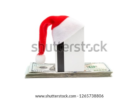 Credit card with Santa's hat and money on white.
