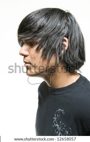 Profile portrait of black hair teen boy listening to music