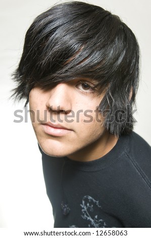 Close up portrait of black hair teen boy with white background