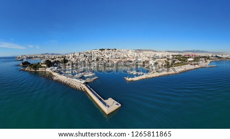 Aerial drone bird's eye view panoramic photo of iconic round shaped picturesque port of Mikrolimano with sail boats and yachts docked and beautiful colours, Pireas port, Attica, Greece