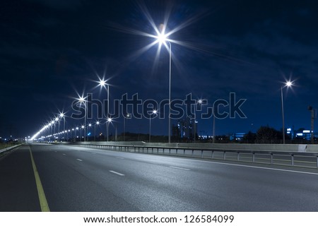 Empty freeway at night Royalty-Free Stock Photo #126584099