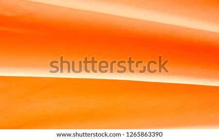 Picture Texture, background Orange silk fabric. It has a wonderful shine with slight color variations to give the look a strip in the fabric. Ideal for adding a touch of luxury to your decor projects