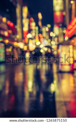 Vintage tone abstract blurred image of Street night market with light bokeh for background usage.
