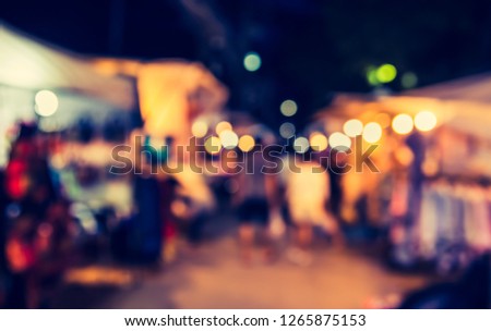 Vintage tone  abstract blur image of Street night market with bokeh for background usage .