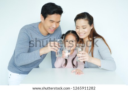 Asian family drinking water with together Royalty-Free Stock Photo #1265911282