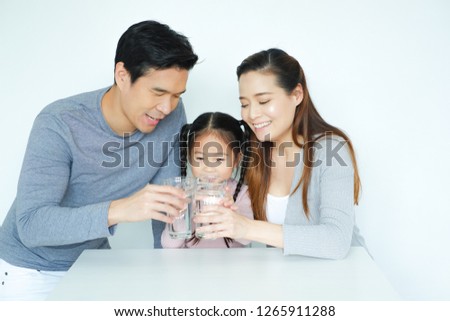 Asian family drinking water with together Royalty-Free Stock Photo #1265911288